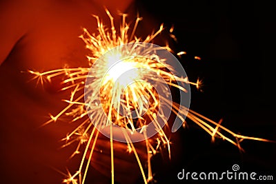 Bengal fire, sparks burning against a dark background, flickering fire, brightly burning holiday fire Stock Photo