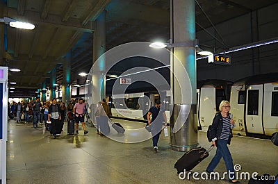 Station London Stansted with arriving passengers and the Stansted Express in background Editorial Stock Photo