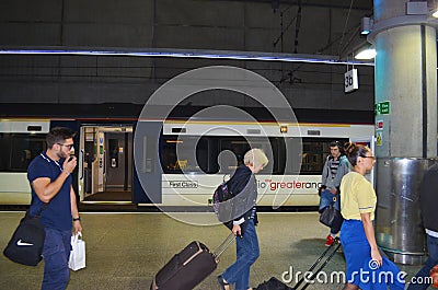 Station London Stansted with arriving passengers and the Stansted Express in background Editorial Stock Photo