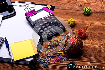 Stationery, calculator and xmas balls. Clip folder with white paper Stock Photo