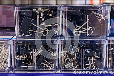 Stationery clothespins in a plastic box close-up, selective focus. Background with copy space Stock Photo