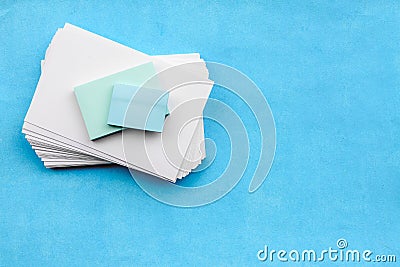 Stationery layout on a blue background-a stack of empty white cards blank for the inscription Stock Photo