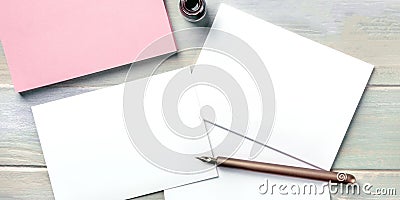 Stationery mock-up with an ink bottle and a nib pen. Blank greeting cards or invitations Stock Photo