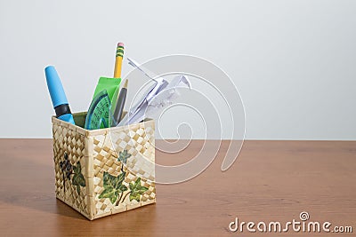 Stationery products and an origami parrot in a box Stock Photo