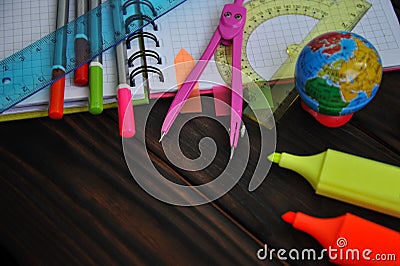 Stationery scattered on a notebook lying on a table Stock Photo