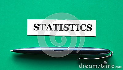STATISTICS - word on a green background with a black handle Stock Photo