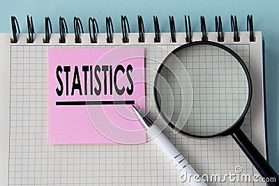 STATISTICS - word in notepad with magnifying glass and pen Stock Photo