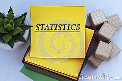 STATISTICS - word on a yellow note paper on a light background with a cactus Stock Photo