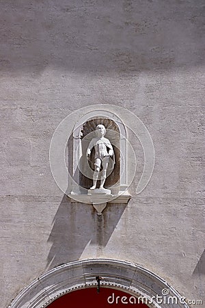 Statue above a red door Stock Photo