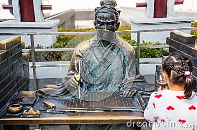 Statue of Acient Chinese Scholar writing on the bable on the bamboo book, in Nanjing, China Editorial Stock Photo