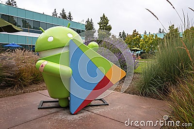 Statue of android with play store logo amidst plants in garden during sunset Editorial Stock Photo