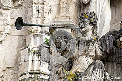 Statue of angel with trumplet on the facade of the ancient Church of the Holy Cross in Coimbra Stock Photo