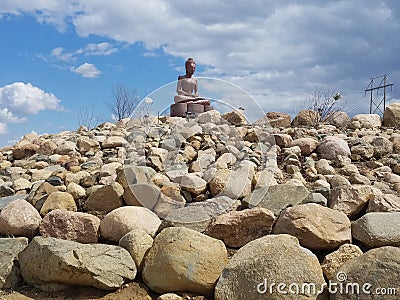 Statue atop rock way Stock Photo