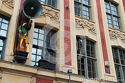 The statue of a bell-ringer and sculptured horns of plenty decorate the facade of a building in Lille (France) Stock Photo