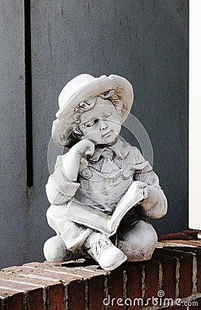Statue of a boy in front of a home in Volendam Stock Photo