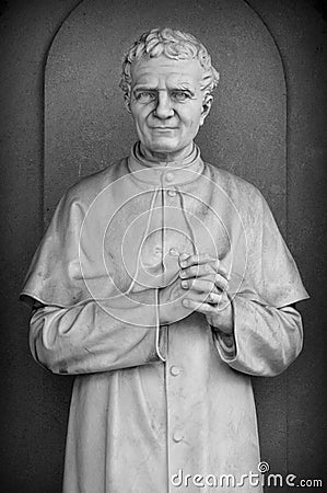 Statue of a Catholic Priest Stock Photo