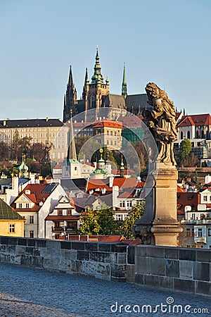 Statue on Charles Brigde against St. Vitus Cathedral in Prague Stock Photo