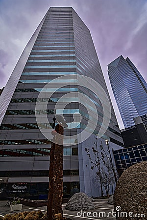 A statue of a crow on the sidewalk near the BOK tower with Devon tower in the background Editorial Stock Photo
