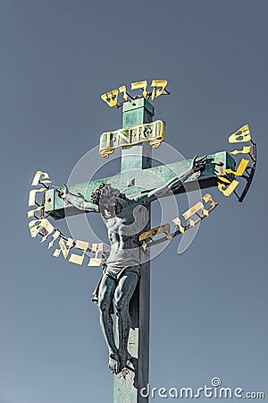 Statue of Crucifixion of Jesus at the Charles Bridge in Prague, Czech Republic Stock Photo