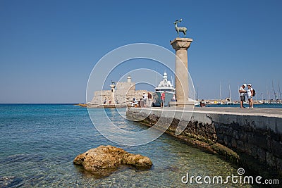Statue Deer and hound and columns in Mandraki harbor. Editorial Stock Photo