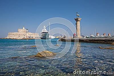 Statue Deer and hound and columns in Mandraki harbor. Editorial Stock Photo