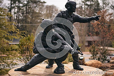 Statue displaying two brave young men in military Editorial Stock Photo