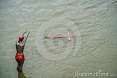 Statue and drifting objects. Editorial Stock Photo