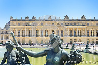 Statue in fountain in front of Palace of Versailles Editorial Stock Photo
