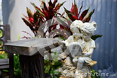 Statue of Girl and Boy reading the book in the garden Stock Photo