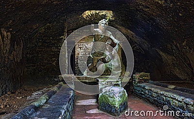 Statue of the god Mithras killing a bull in the thermal s mithraeum in archaeological excavations of Ostia Antica - Rome Stock Photo