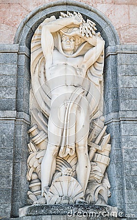 Statue of the god Neptune on the facade a hydroelectric plant. Stock Photo