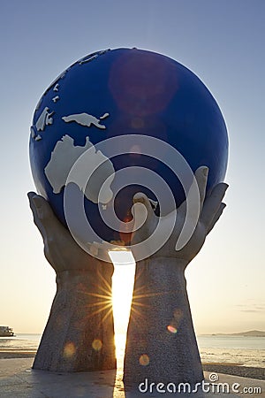 Statue of hands lifting earth Editorial Stock Photo