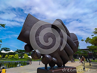 statue of hands shaking hands at Kiara Artha Park Bandung. Editorial Stock Photo