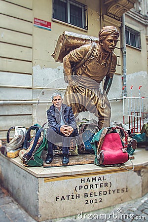 Statue of a hard working porter, Hamal, at Fatih district and living porter nowadays Editorial Stock Photo