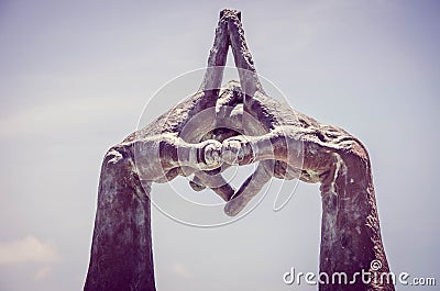 Statue with Interlocked Hands in Park Stock Photo