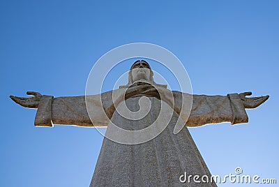 Statue of Jesus Christ, Cristo Rei, standing atop a hill in Lisbon, Portugal Editorial Stock Photo