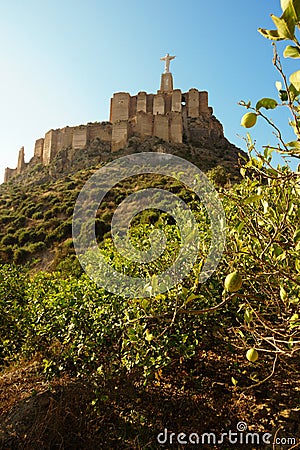 The statue of Jesus Christ on top of a fortress on a mountain in the city of Monteagudo in Spain Stock Photo