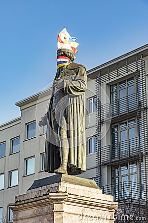 Statue of Johannes Gutenberg dressed with a carnival cap and mask in Mainz Editorial Stock Photo