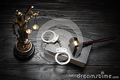 Statue of Lady Justice, handcuffs, book and gavel Stock Photo