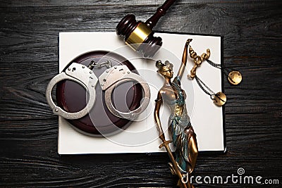 Statue of Lady Justice, handcuffs, book and gavel Stock Photo