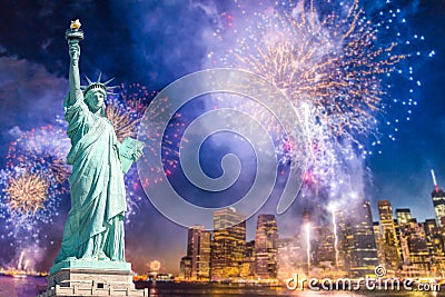 The Statue of Liberty with blurred background of cityscape with beautiful fireworks at night, Manhattan, New York City Stock Photo