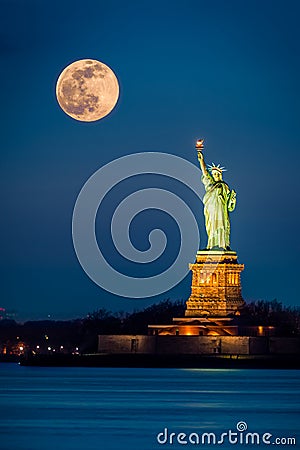 Statue of Liberty and a rising supermoon Stock Photo