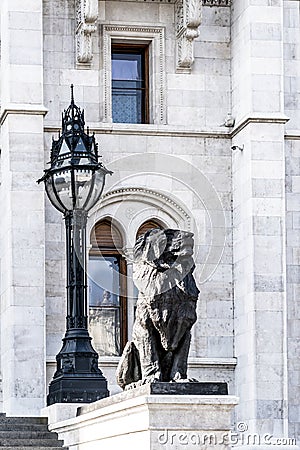 Statue of a lion and a decorative streetlight Stock Photo