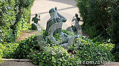 Statue mermaid in the bush Stock Photo