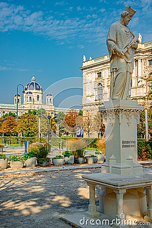 Statue of priest with figure of crucified Jesus in Vienna downtown at blue sky and magical Autumn light, Austria, details, closeup Editorial Stock Photo