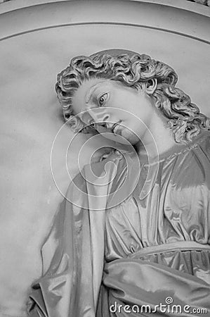 Statue of a pure angel without wings. Candid child`s face, black and white photo. Editorial Stock Photo