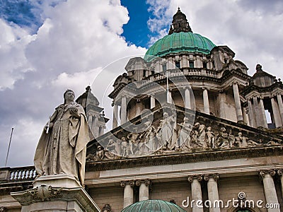 The statue of Queen Victoria in front of Belfast City Hall. The lantern-crowned 173 ft 53 m green copper dome appears Editorial Stock Photo