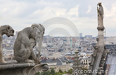 Statue on the roof of the cathedral of Notre Dame in Paris while Stock Photo