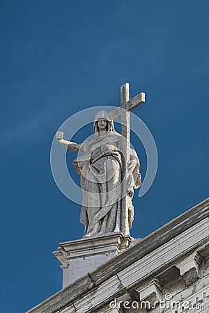 Statue of Saint with cross at San Stae catholic Church in Venice Stock Photo