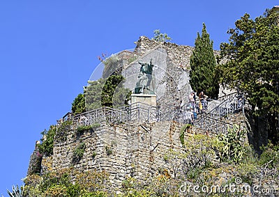 Statue of Saint Francis of Assisi taming the Wolf of Gubbio in Monterrosso, Italy Editorial Stock Photo